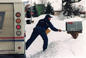 Mailman delivering mail in dangerous snowy conditions